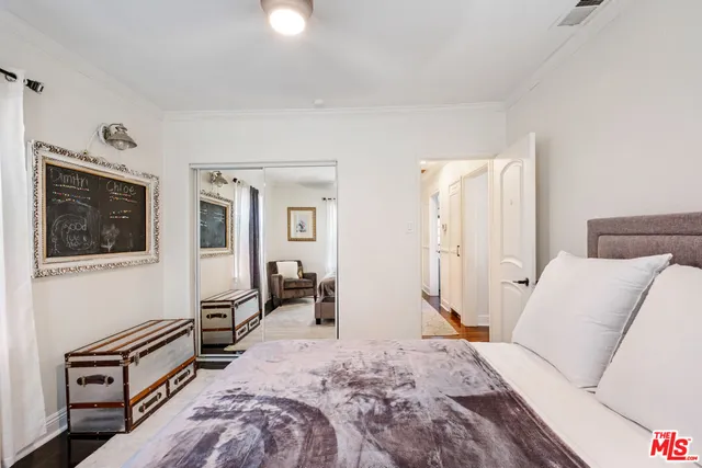 a bedroom with furniture and a flat screen tv