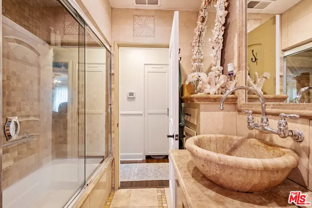 a bathroom with a tub and shower