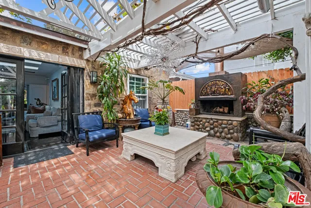 a outdoor living space with patio furniture and a fireplace