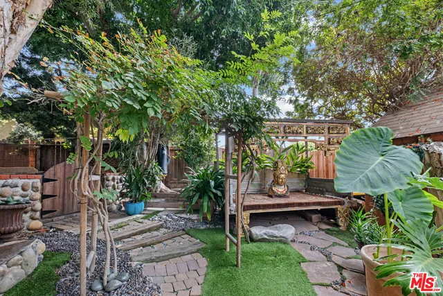 a backyard of a house with barbeque oven and outdoor seating