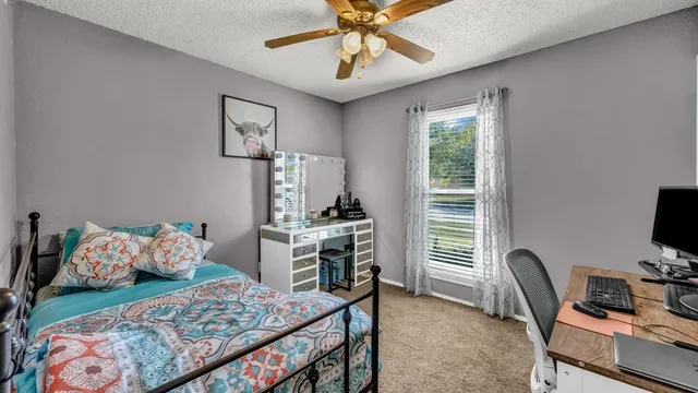 a bedroom with a bed and a chair