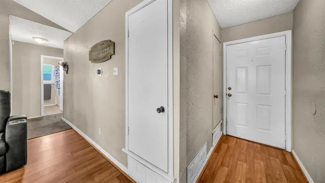 a view of a hallway with wooden floor