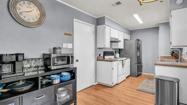 a kitchen with stainless steel appliances a refrigerator sink and cabinets