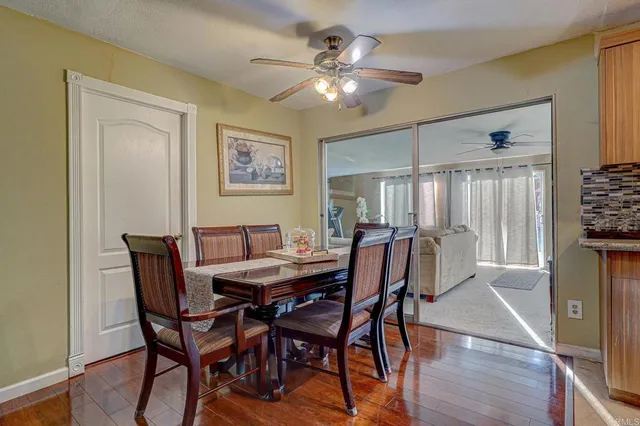 a view of a dining room with furniture and a chandelier