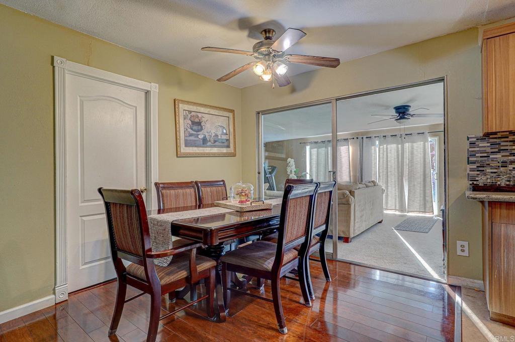 a view of a dining room with furniture and a chandelier