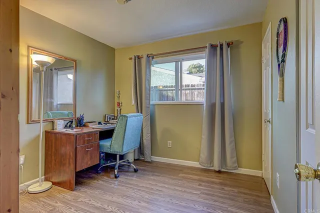 a view of a workspace with furniture and a window