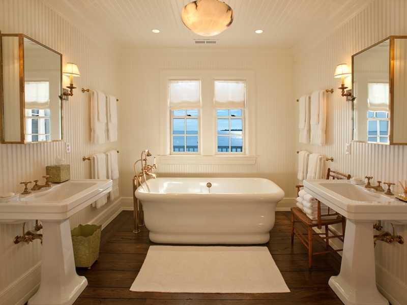 18 Rocky Point Road Rowayton, CT 06853 - Photo 17 of 24 a bathroom with a tub sink and mirror