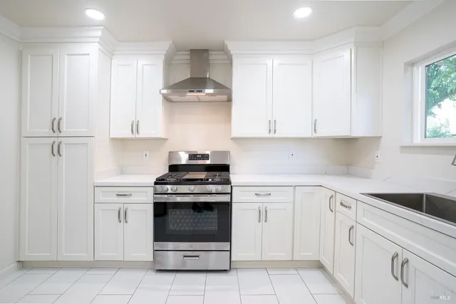a kitchen with white cabinets and white appliances