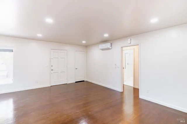 an empty room with wooden floor