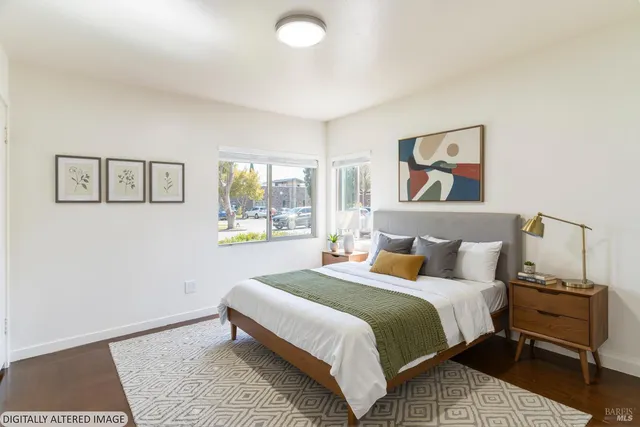 a bedroom with a bed and a wall painting