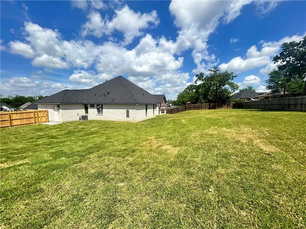 a view of a patio with a table and chairs under an umbrella