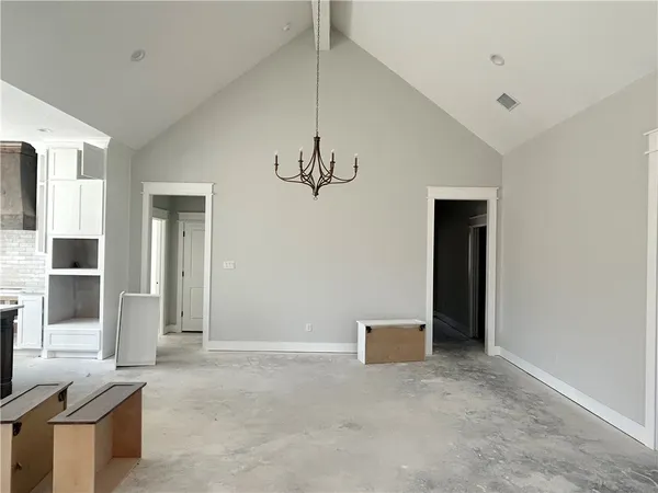 a view of an empty room with window and cabinet