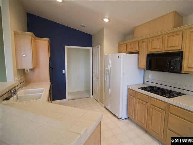 2225 Ridgeview Drive Reno, NV 89519 - Photo 5 of 12 a kitchen with stainless steel appliances a refrigerator stove and microwave