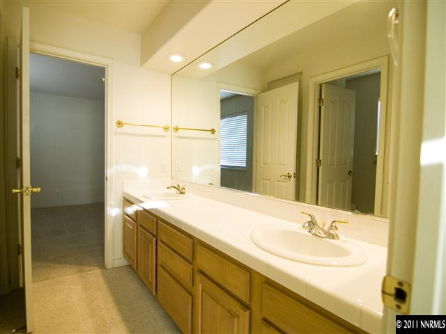 2225 Ridgeview Drive Reno, NV 89519 - Photo 10 of 12 a bathroom with a sink and a mirror