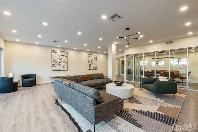 a view of a patio with couches table and chairs and potted plants