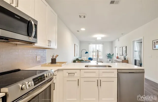 a kitchen with a sink stove and microwave
