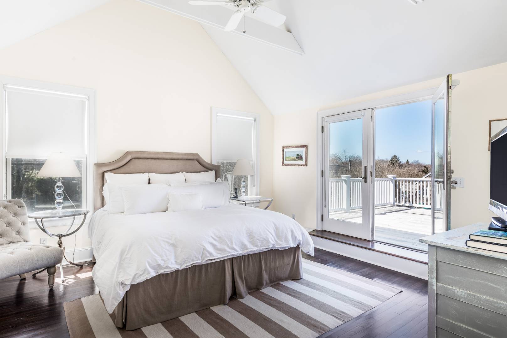 56 Butter Lane Bridgehampton, NY 11932 - Photo 11 of 18 a bedroom with a large bed and a chandelier