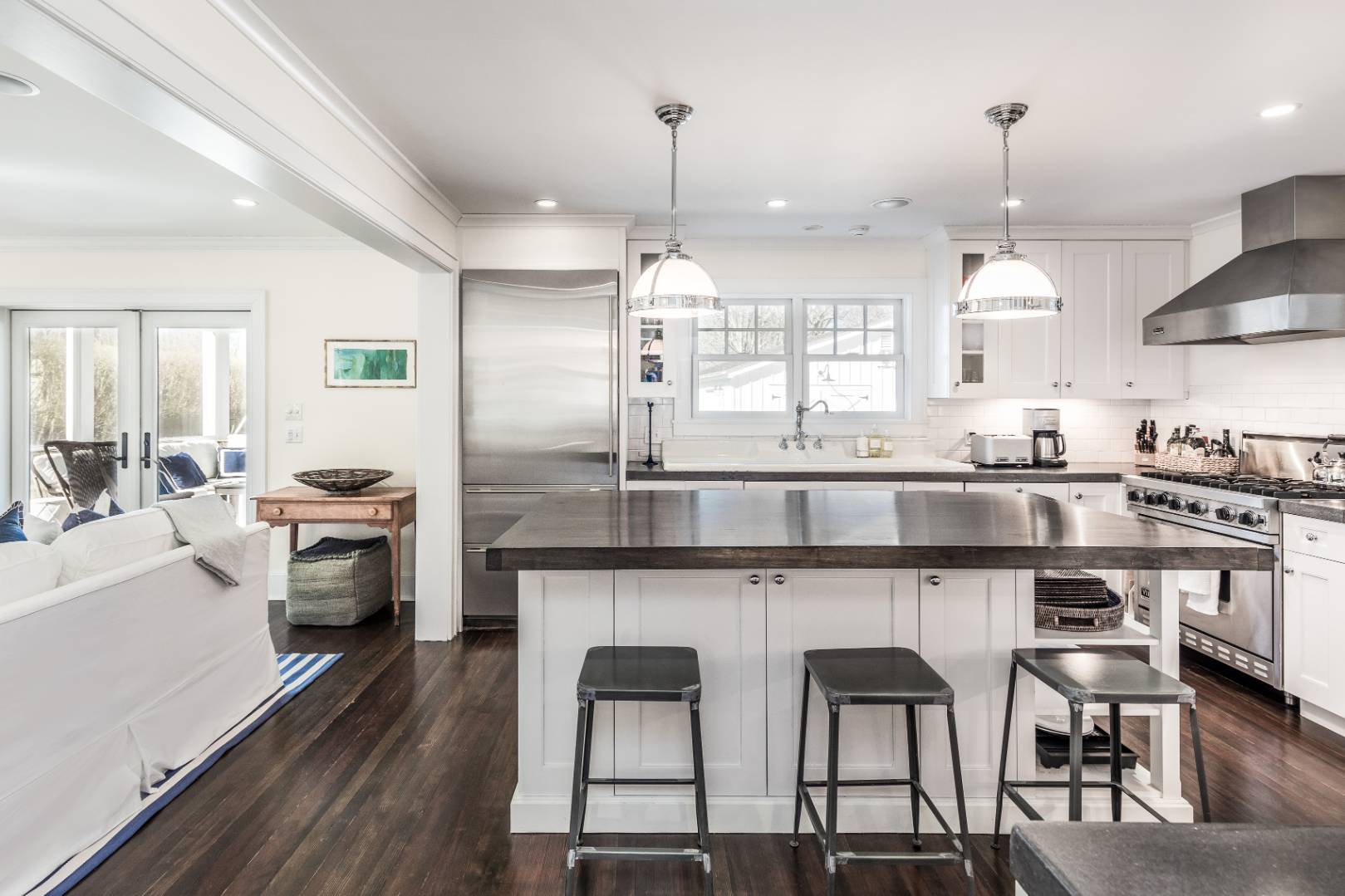 56 Butter Lane Bridgehampton, NY 11932 - Photo 7 of 18 a kitchen with a dining table chairs stainless steel appliances and cabinets