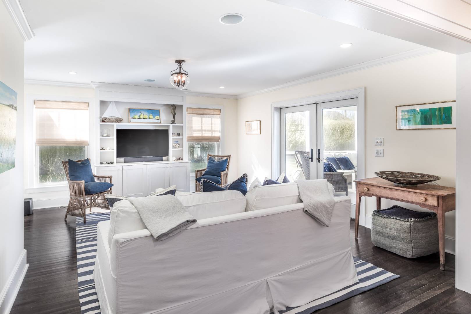 56 Butter Lane Bridgehampton, NY 11932 - Photo 8 of 18 a living room with furniture a flat screen tv and kitchen view