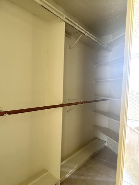 14702 Rancho Vista Drive Houston, TX 77083 - Photo 11 of 18 a view of walk in closet with empty racks