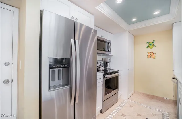 a view of a dining room with furniture a chandelier and wooden floor