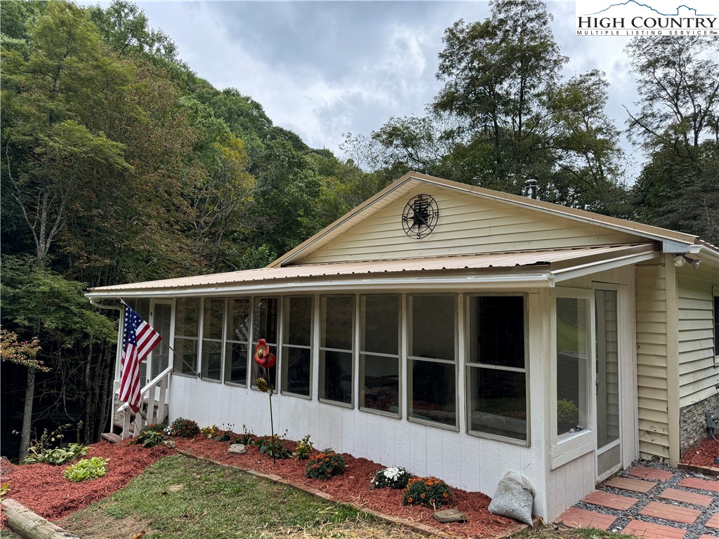 321 Skin Camp Creek Road Todd, NC 28684 - Photo 23 of 29 a front view of a house with a garden