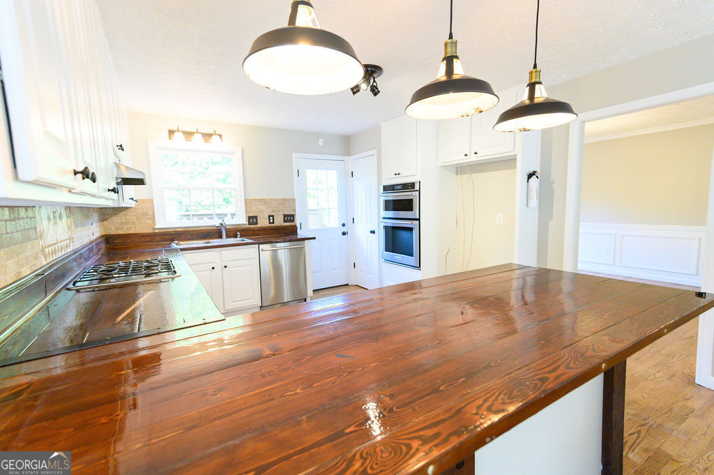 3301 Connie Way Winston, GA 30187 - Photo 15 of 40 a kitchen with stainless steel appliances granite countertop a sink stove and refrigerator