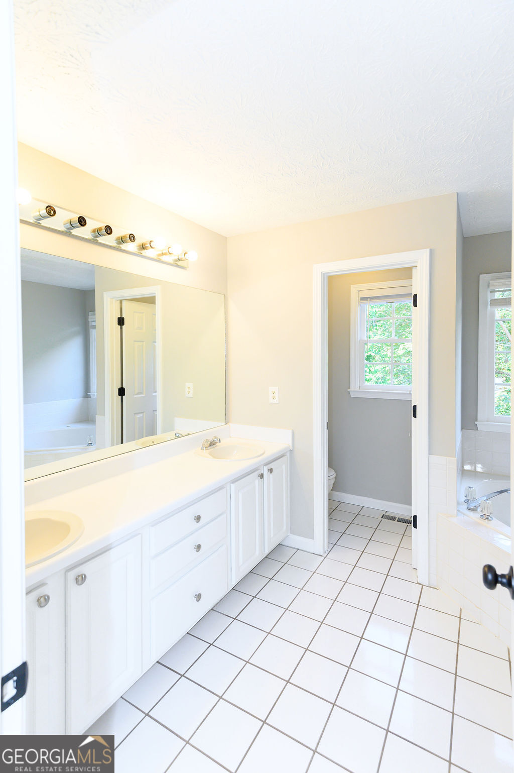 3301 Connie Way Winston, GA 30187 - Photo 22 of 40 a spacious bathroom with a mirror a sink and vanity
