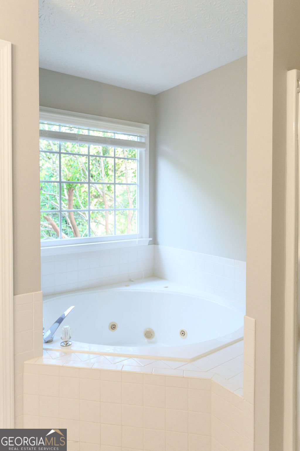 3301 Connie Way Winston, GA 30187 - Photo 23 of 40 a white bath tub sitting next to a window