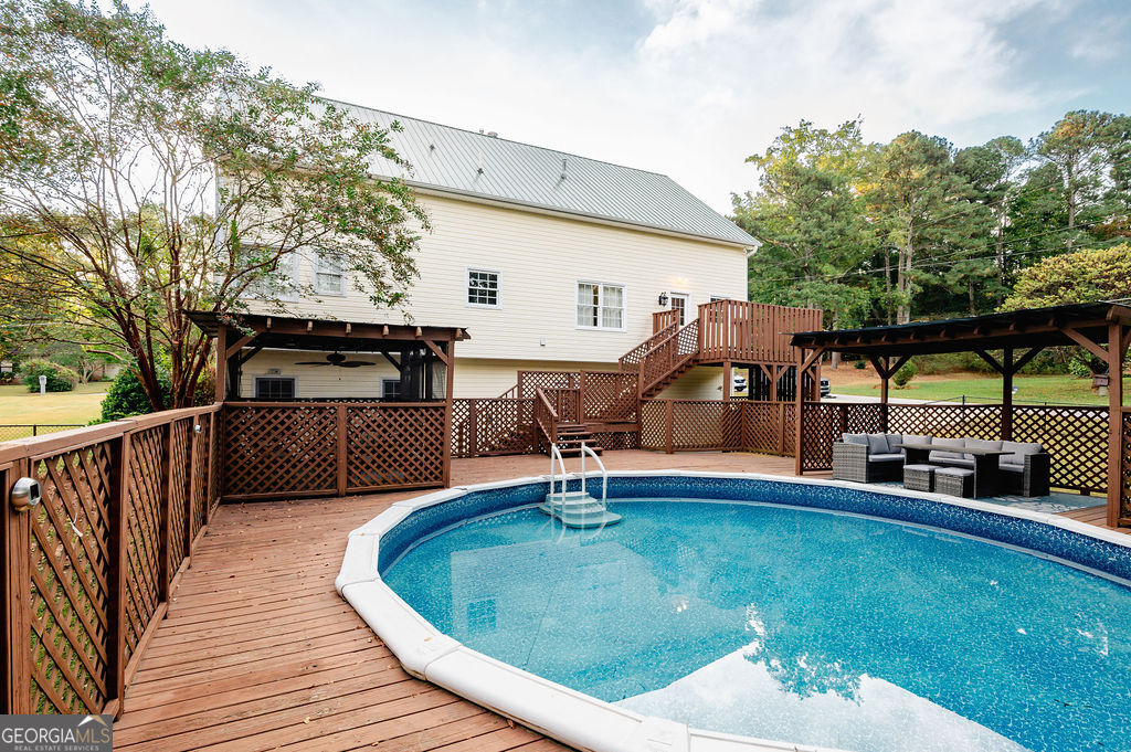 3301 Connie Way Winston, GA 30187 - Photo 4 of 40 a swimming pool with outdoor seating and yard