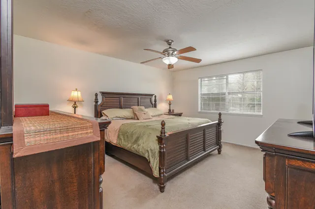 a bedroom with a large bed and a window