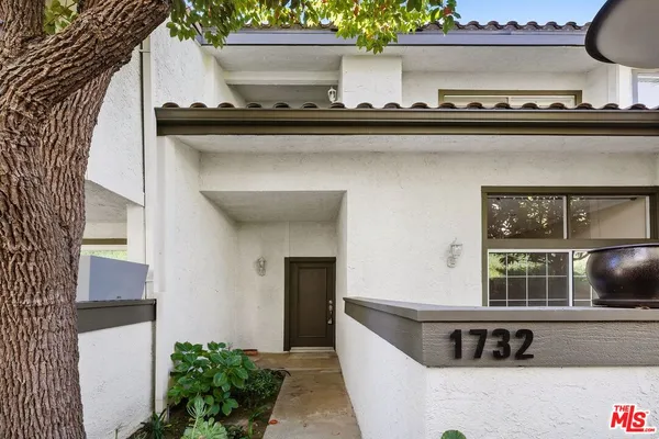 a view of living room with furniture and potted plant