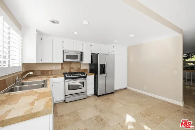 a large white kitchen with a window