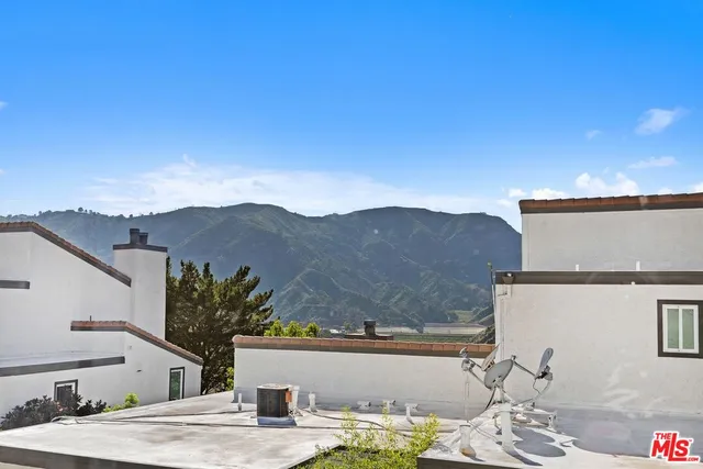 en empty room with windows and fireplace