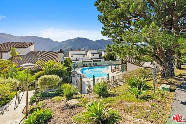 a view of a swimming pool with chairs