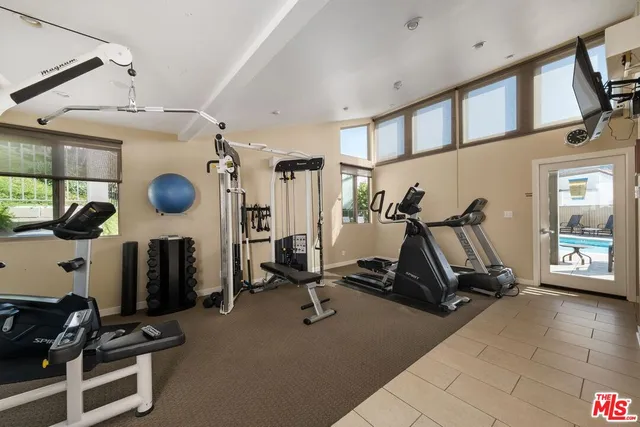 an aerial view of a multi story residential apartment building with yard