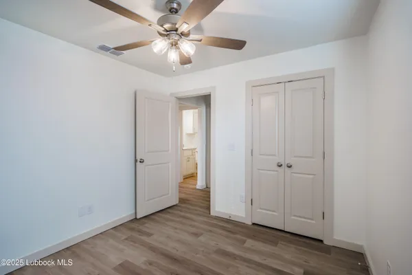 a view of an empty room with a fan