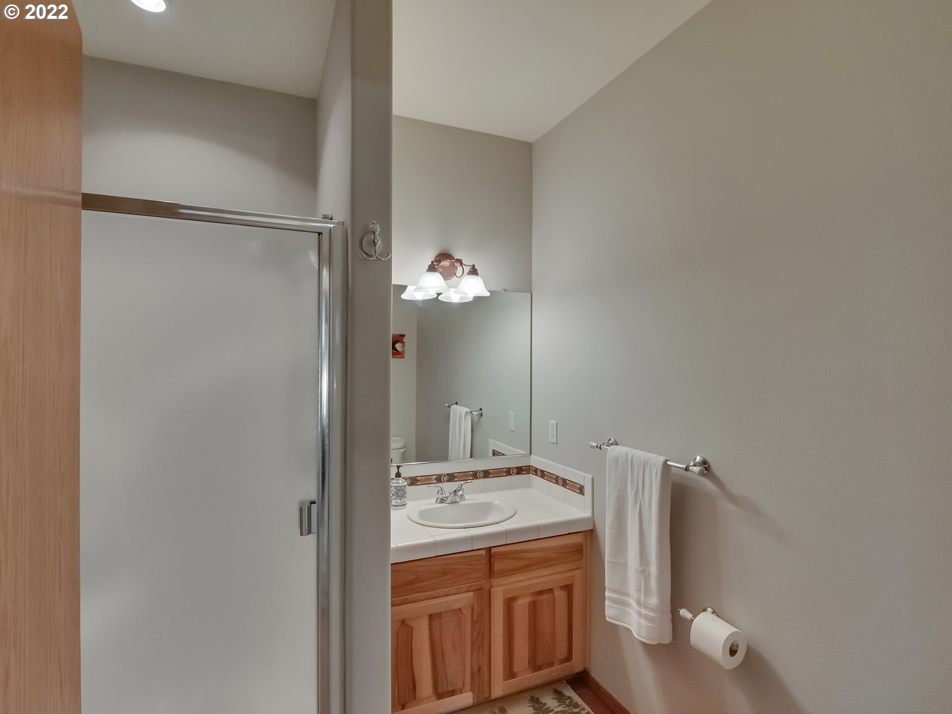 3000 Northwest 299th Street Ridgefield, WA 98642 - Photo 14 of 35 a bathroom with a granite countertop sink a toilet and a mirror