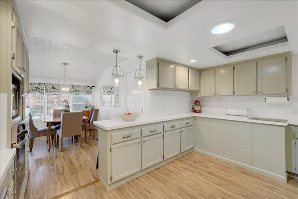 a kitchen with a sink cabinets and wooden floor