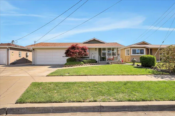 a front view of a house with a yard