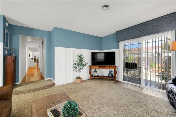 a living room with furniture a fireplace and a flat screen tv