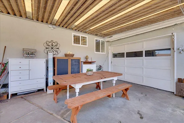 a view of a house with backyard and sitting area