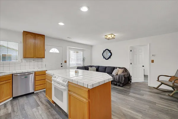 a kitchen with kitchen island a sink counter and chairs