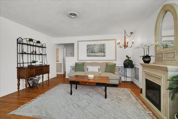 a living room with furniture a fireplace and a table