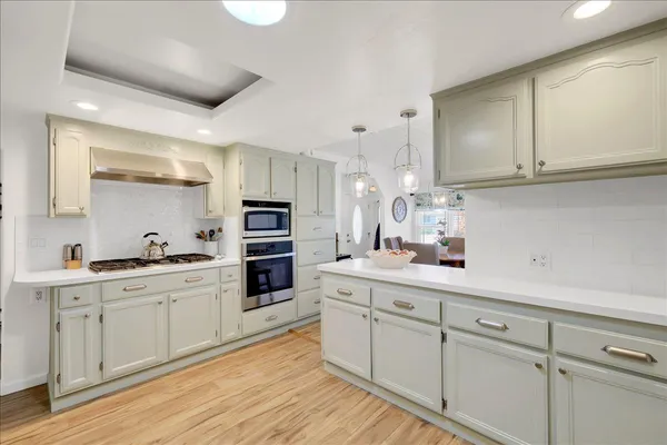 a kitchen with stainless steel appliances granite countertop a sink and cabinets