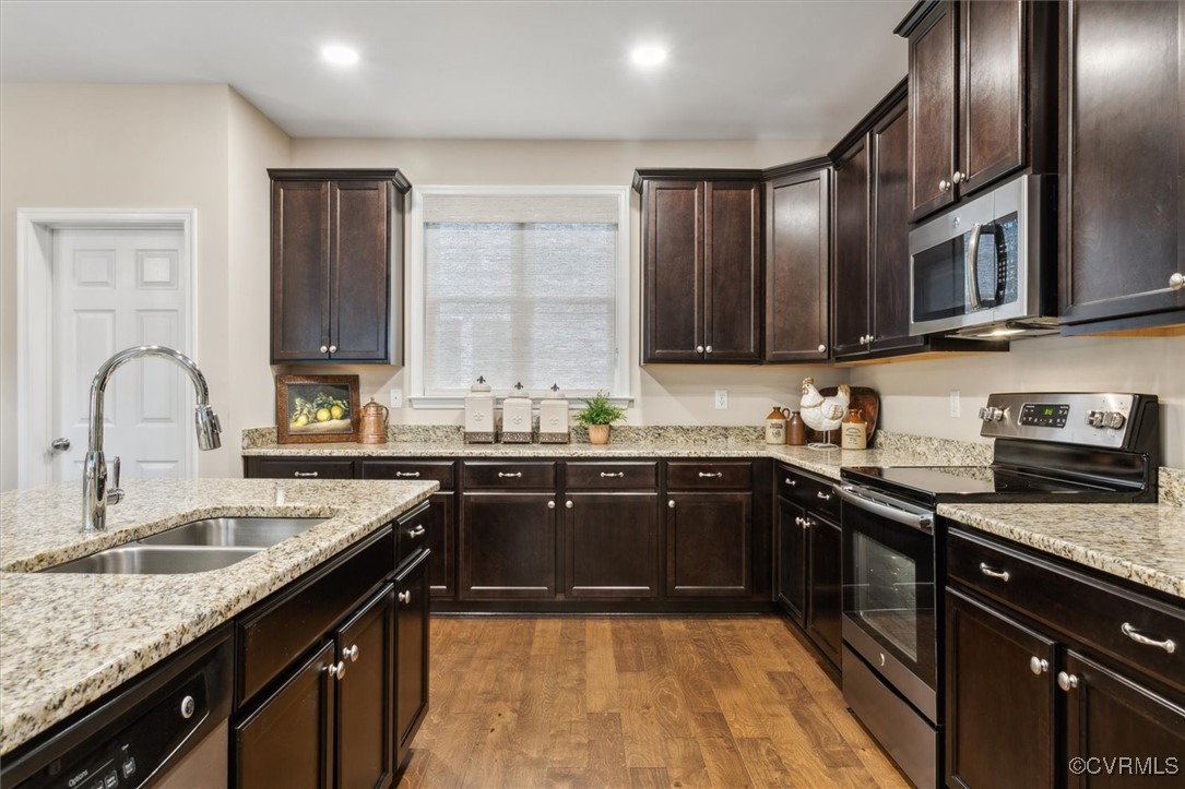 5587 Brixton Road Williamsburg, VA 23185 - Photo 15 of 42 a kitchen with stainless steel appliances granite countertop a sink stove and refrigerator