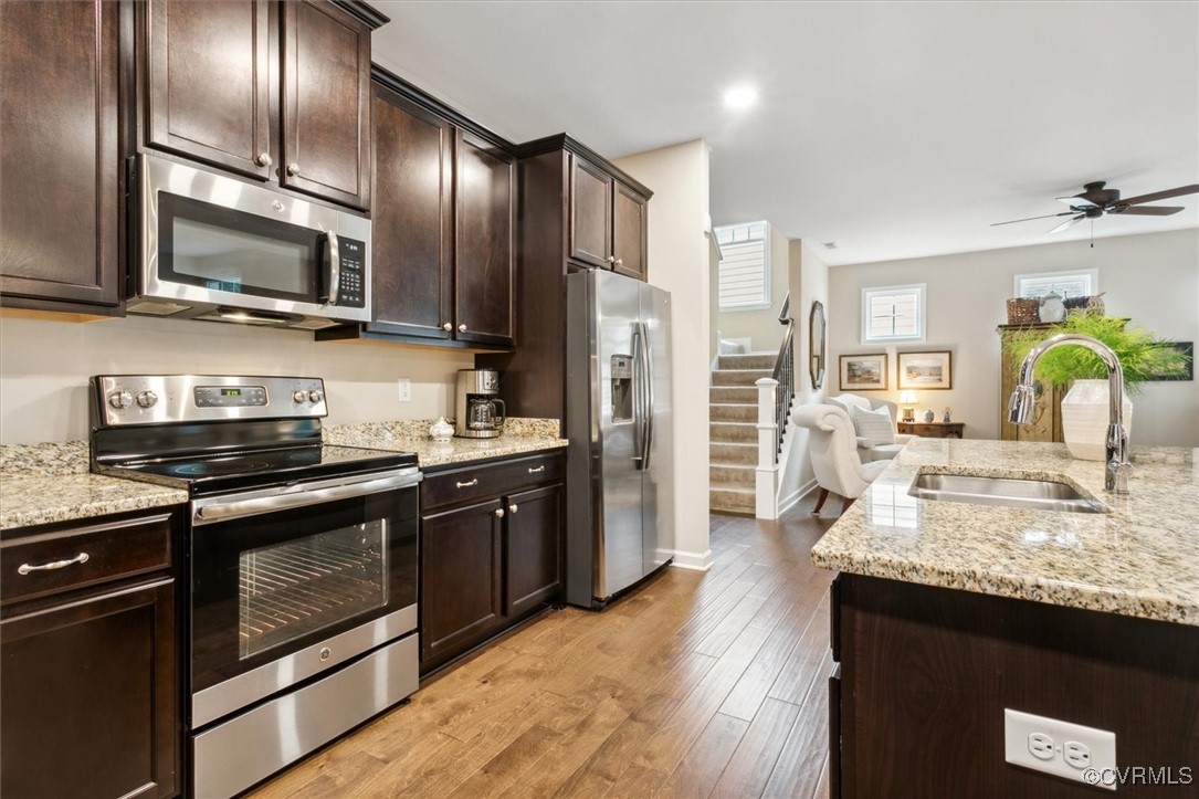 5587 Brixton Road Williamsburg, VA 23185 - Photo 17 of 42 a large kitchen with granite countertop stainless steel appliances and wooden floor