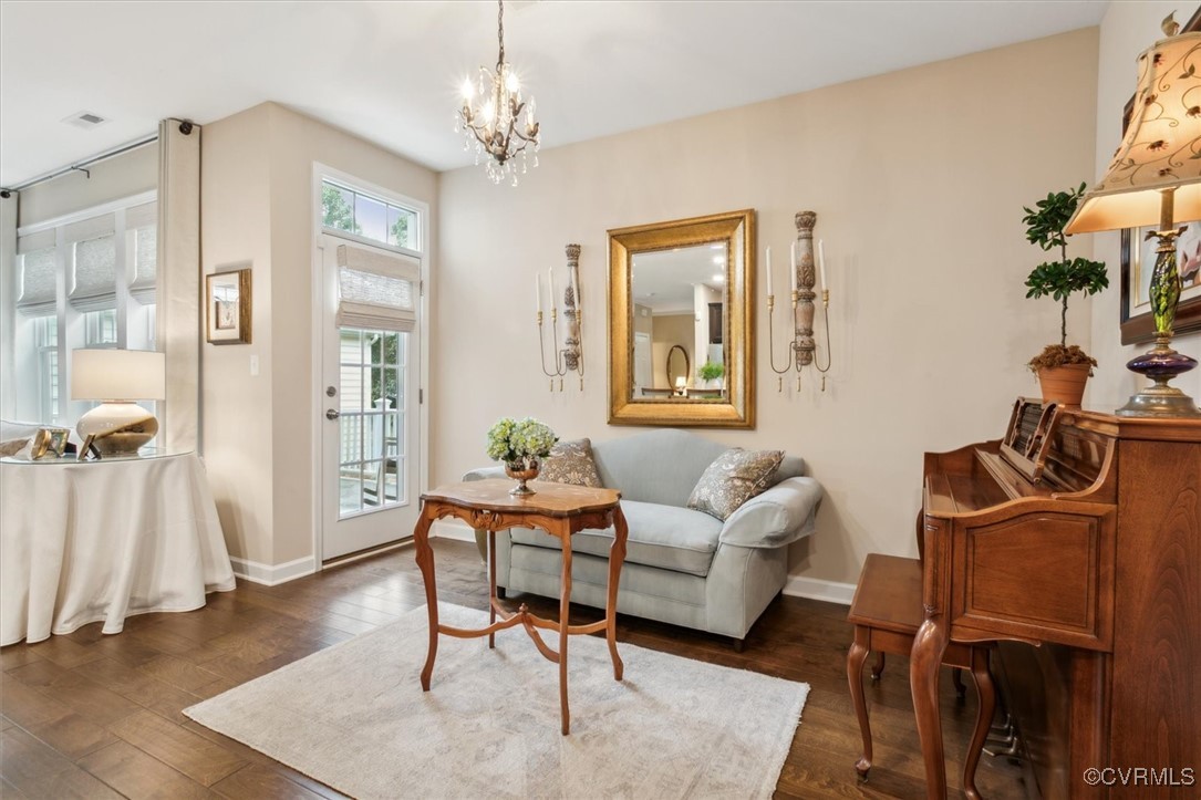5587 Brixton Road Williamsburg, VA 23185 - Photo 20 of 42 a living room with furniture and a chandelier