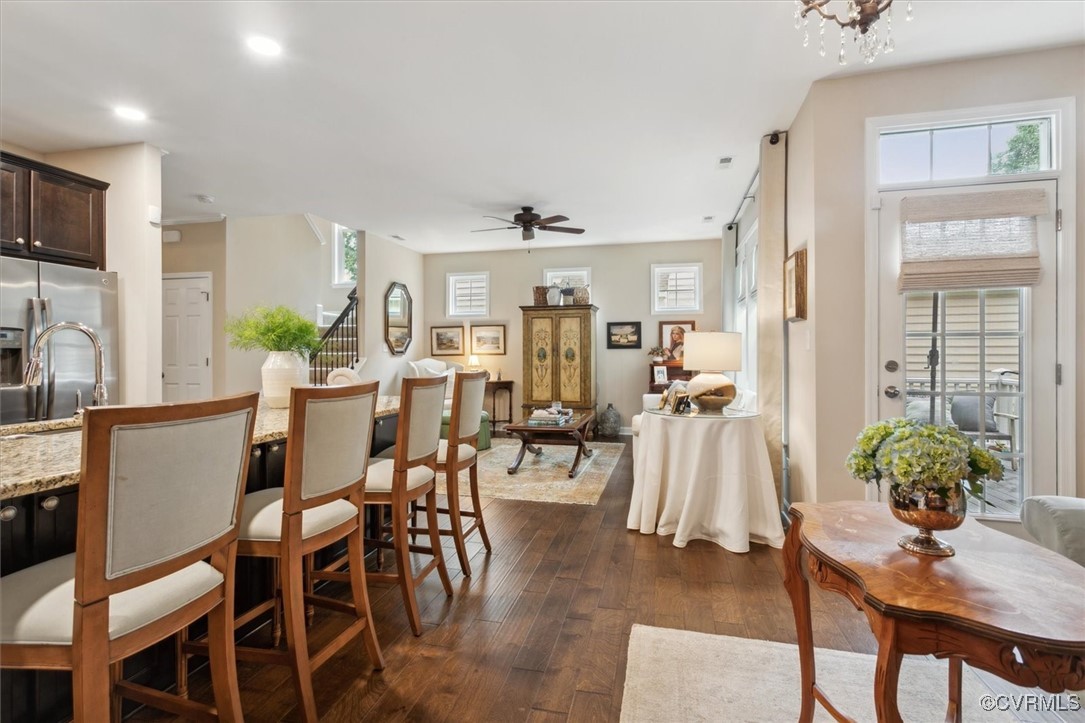 5587 Brixton Road Williamsburg, VA 23185 - Photo 22 of 42 a living room with furniture a dining table and a flat screen tv