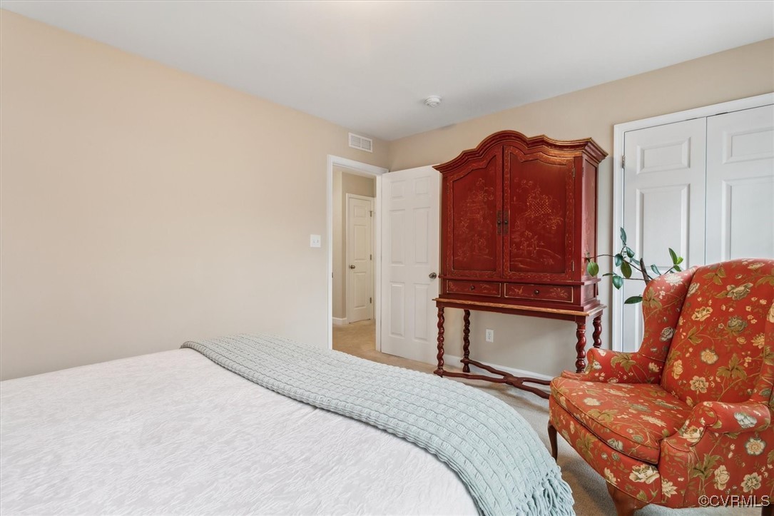 5587 Brixton Road Williamsburg, VA 23185 - Photo 26 of 42 a bedroom with a bed and a dresser